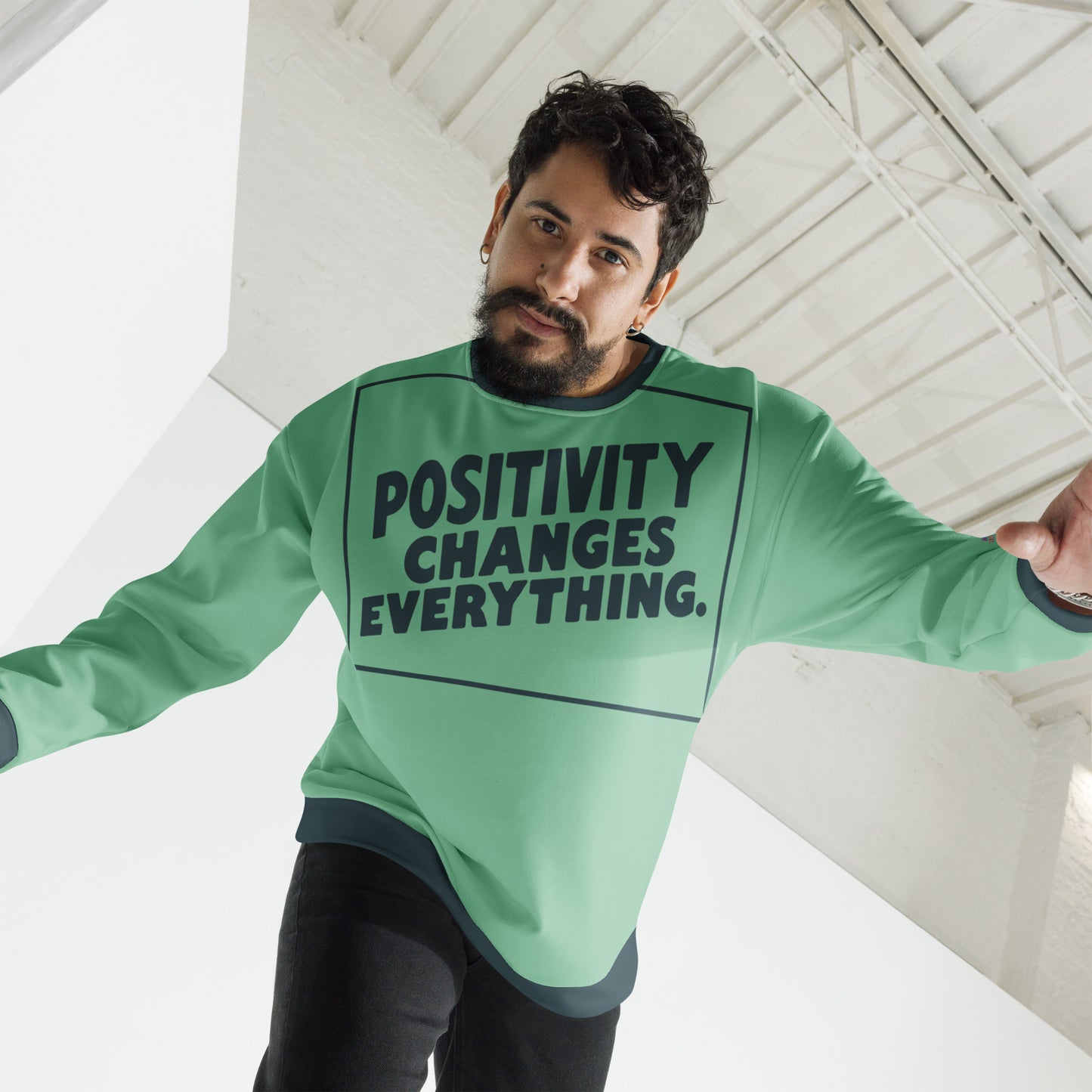 This unisex sweatshirt is a new arrival with "POSITIVITY CHANGES EVERYTHING" in a bold, dark teal tilt. Made with recycled materials for ultimate comfort.