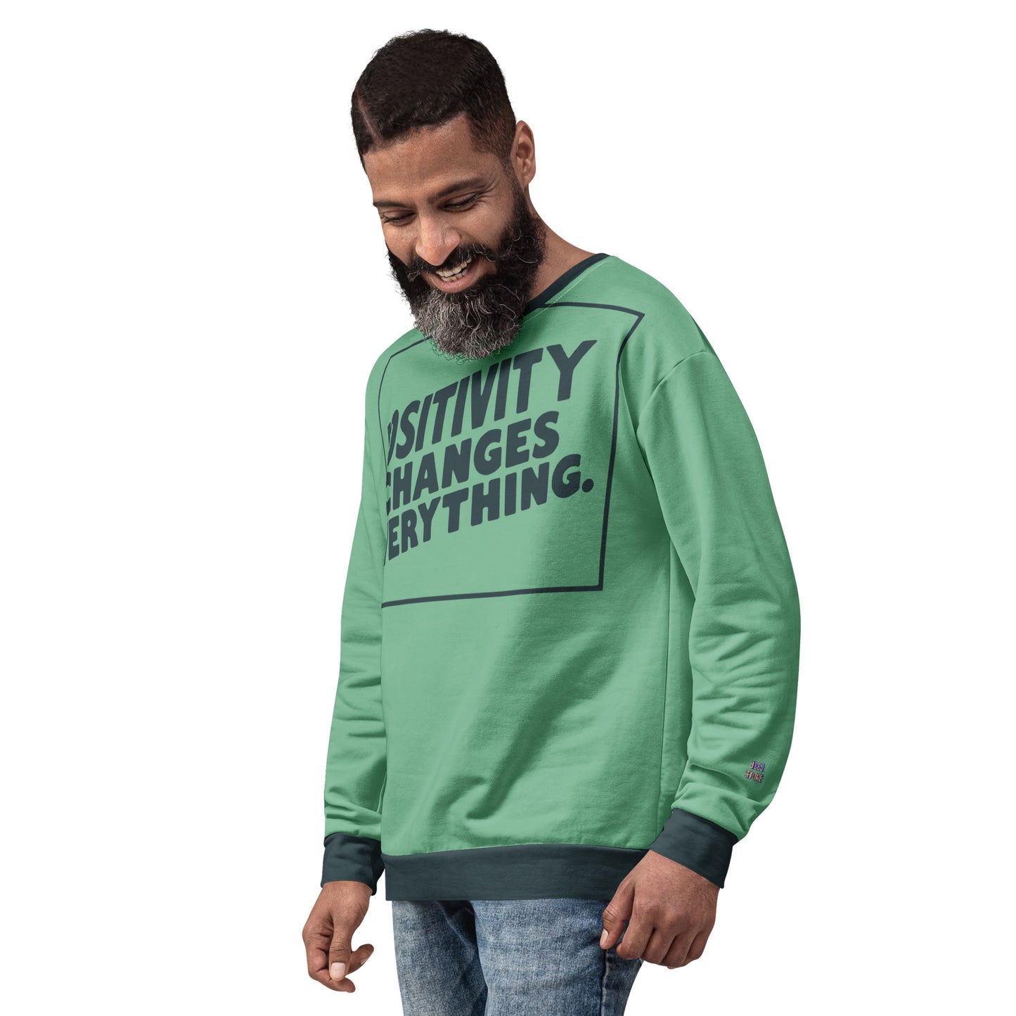 This unisex sweatshirt is a new arrival with "POSITIVITY CHANGES EVERYTHING" in a bold, dark teal tilt. Made with recycled materials for ultimate comfort.
