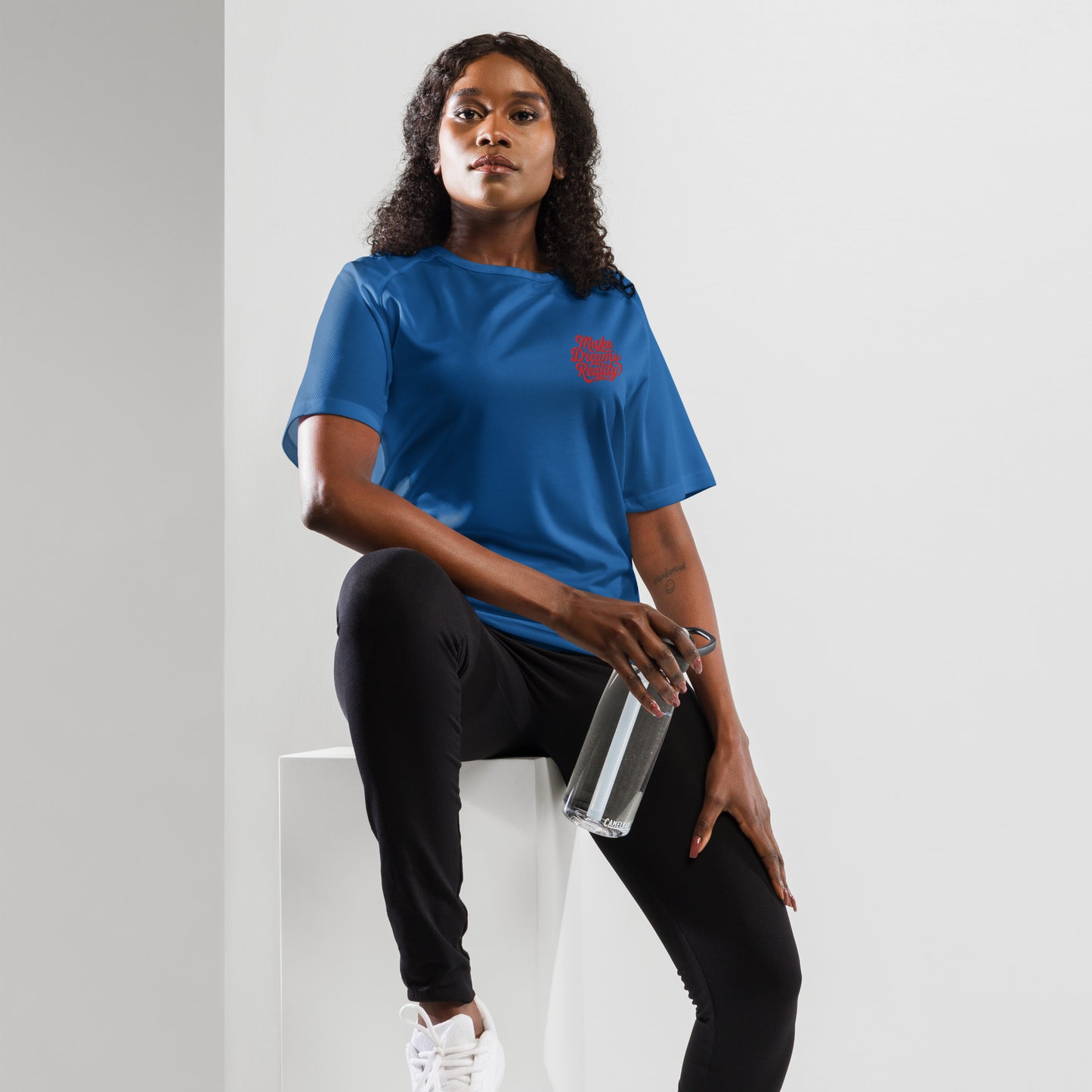 This optimal ventilation shirt in navy features "Make Dreams Reality." Breathable polyester mesh ensures cool comfort for workouts and leisure.