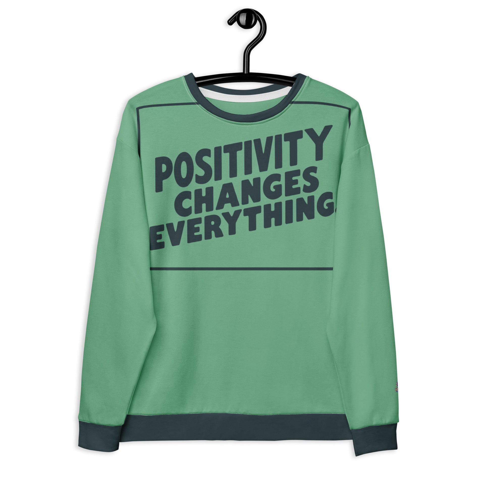 This unisex sweatshirt is a new arrival with "POSITIVITY CHANGES EVERYTHING" in a bold, dark teal tilt. Made with recycled materials for ultimate comfort.