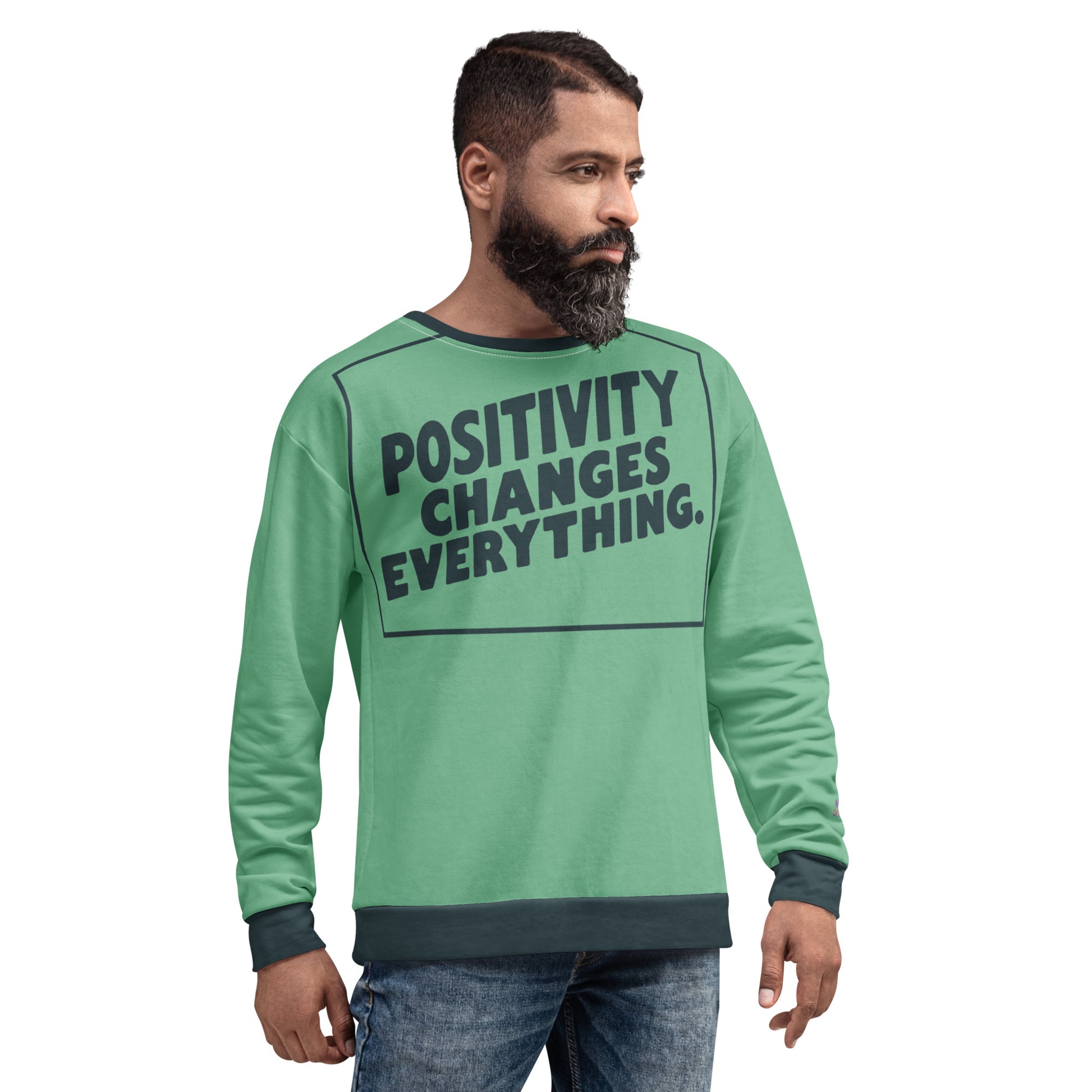 This unisex sweatshirt is a new arrival with "POSITIVITY CHANGES EVERYTHING" in a bold, dark teal tilt. Made with recycled materials for ultimate comfort.